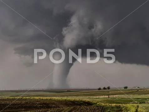 A large cone tornado touches down over the open prairie Stock Photos
