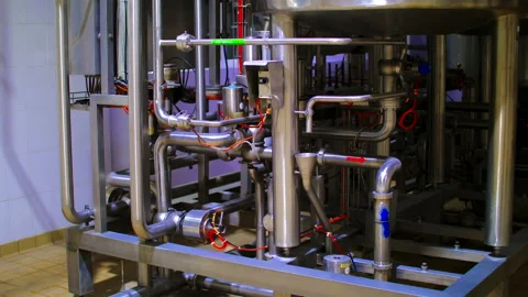 A large construct of pipes and tubes with valves on a food factory Stock Footage 150517839