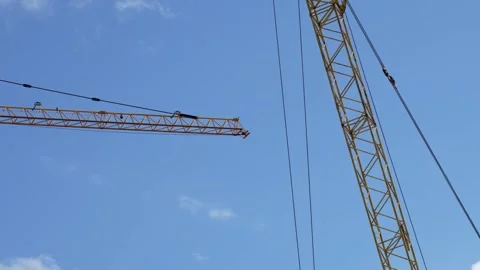 Large Construction Cranes Against a Blue Sky Stock Footage 313273445