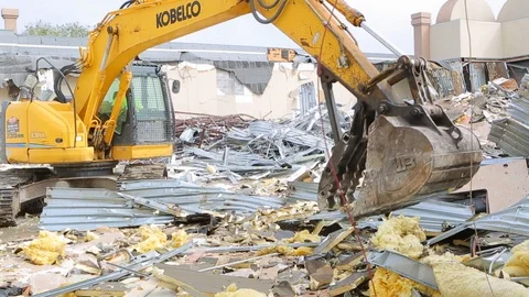Large construction equipment throws metal scraps at demoliton site B Stock Footage 125056810