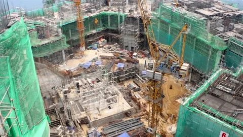 Large Construction Site With Cranes and Buildings on a Mountain Landscape Stock Footage 315430265