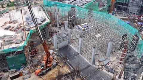 Large Construction Site With Cranes and Buildings on a Mountain Landscape Stock Footage 316099088