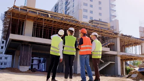 In a large construction site group of specialists and foreman together have a Video stock 146603149