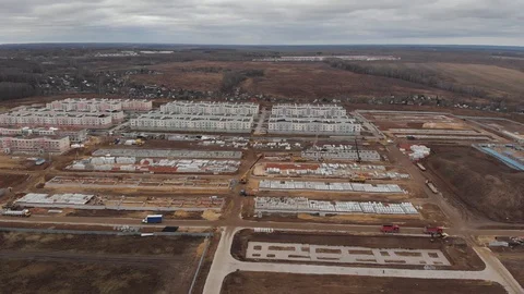 Large construction site including several cranes working on a building complex Stock Footage 120849334