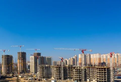 Large construction site including several cranes working on a building complex Stock Photos