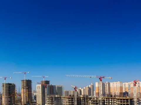 Large construction site including several cranes working on a building complex Stock Photos