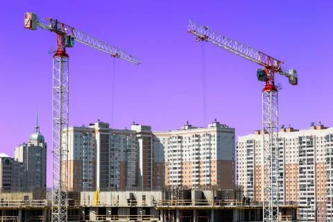 Large construction site including several cranes working on a building complex Stock Photos