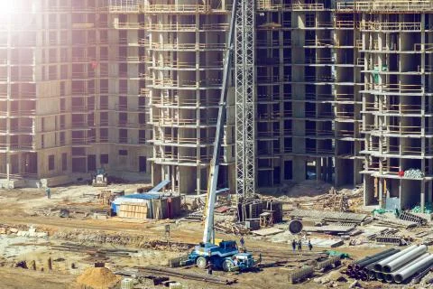 Large construction site including several cranes working on a building complex Stock Photos