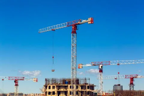 Large construction site including several cranes working on a building complex Stock Photos