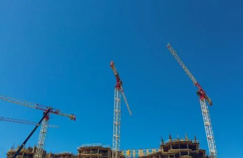 Large construction site including several cranes working on a building complex Stock Photos