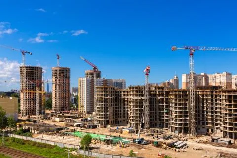 Large construction site including several cranes working on a building complex Stock Photos