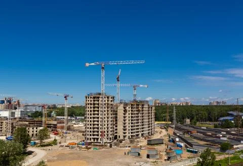 Large construction site including several cranes working on a building complex Stock Photos