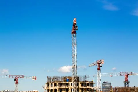 Large construction site including several cranes working on a building complex Stock Photos