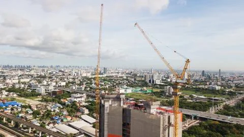 Large construction site including several cranes working on a building comple Stock Photos