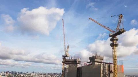 Large construction site including several cranes working on a building comple Stock Photos