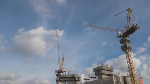 Large construction site including several cranes working on a building comple Stock Photos
