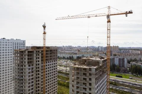 Large construction site including several cranes working on a building complex Stock Photos