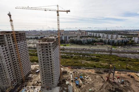 Large construction site including several cranes working on a building complex Stock Photos