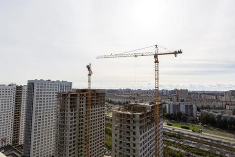 Large construction site including several cranes working on a building complex Stock Photos