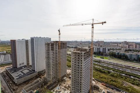 Large construction site including several cranes working on a building complex Stock Photos
