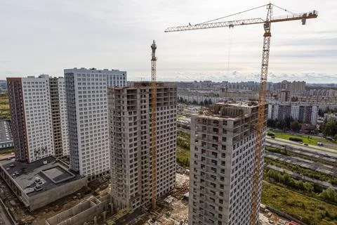 Large construction site including several cranes working on a building complex Stock Photos