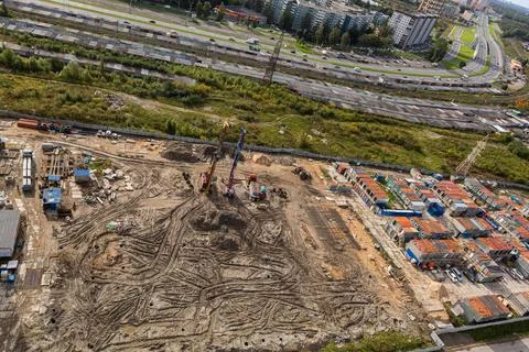Large construction site including several cranes working on a building complex Stock Photos