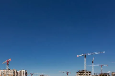 Large construction site including several cranes working on a building complex Stock Photos