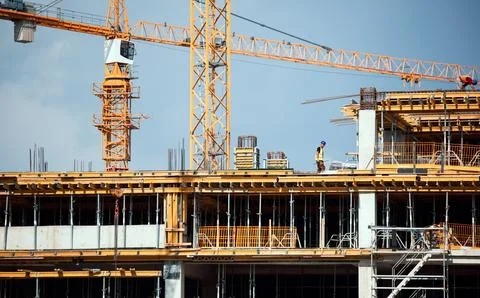 Large construction site including several cranes working on a building complex Stock Photos