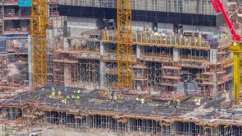Large construction site with many working cranes timelapse. Stock-Fotos