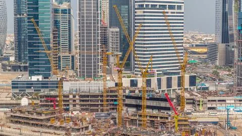 Large construction site with many working cranes timelapse. Stock Photos