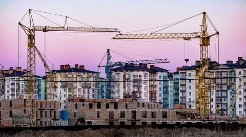 Large construction site with several cranes working on a construction complex Stock Photos
