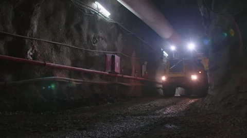 Large construction trucks working inside a tunnel Stock Footage 92186599