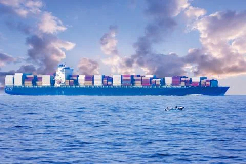 Large container cargo ship in the ocean, side view. Stock Photos