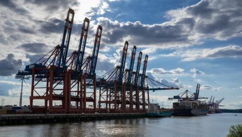 Large container cranes at a dock side Waltershof in Hamburg, Germany. Stock Photos