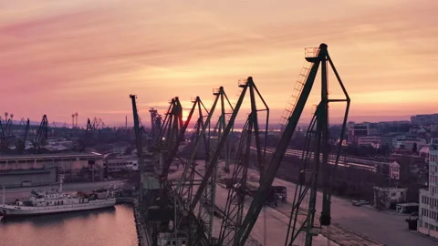 Large Container Cranes silhouettes In The sea Port on Red Light sunset aerial Stock Footage 237951998