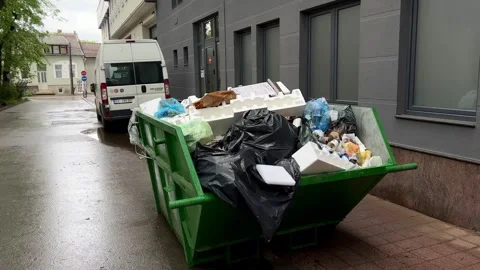 A large container with garbage on the street next to the shopping center Stock Footage 241176906