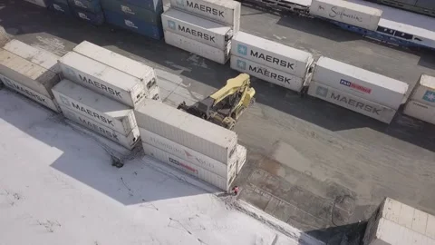 A large container handler moves around the warehouse and sets up containers Stock Footage 157692033