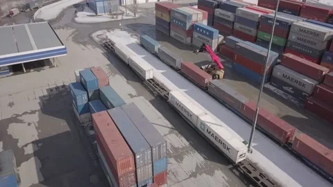 A large container handler moves around the warehouse and sets up containers Stock Footage 157692061