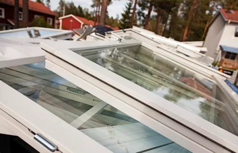 A large container with old windows thrown in a pile Stock Photos
