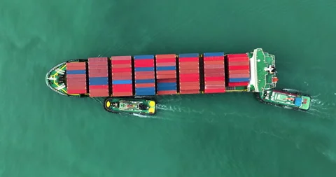 Large Container Ship Assisted By Tugboats In Calm Coastal Waters Aerial View Stock Footage 336304563