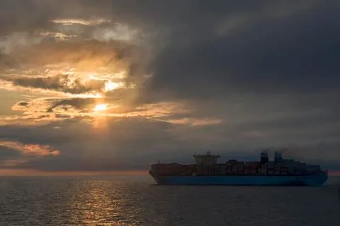 Large container ship on the background of sunset side view Stock Photos