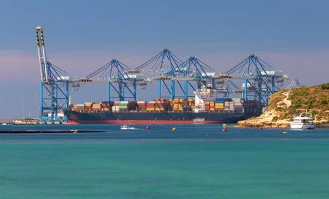 Large container ship being loaded at the cargo port of Malta. Stock Photos