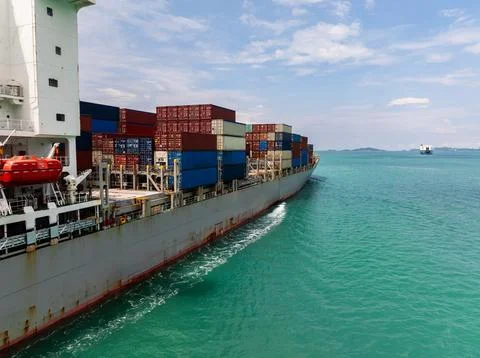 Large Container Ship Carrying Intermodal Freight Across Open Turquoise Ocea.. Stock Photos