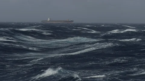 Large container ship heading in rough sea on tailwind Stock Footage 121499353