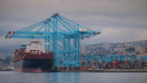 Large container ship loading and unloading crane operations at a busy port Stock Footage 333291468