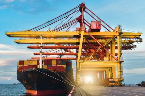 Large container ship loading and discharging container cargo at seaport. Stock Photos