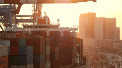 Large container ship loading in the commercial port of genoa at sunset Stock Footage 160764923