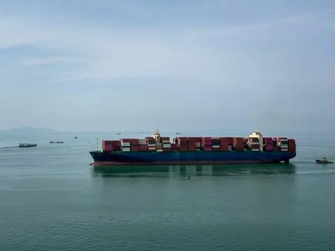 Large Container Ship Navigating Across Calm Open Ocean Wide Angle Shot Stock Photos