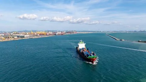 Large Container Ship Navigating Busy Harbor Waters In Thailand Wide Shot Foto stock
