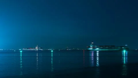 Large Container Ship Navigating Calm Ocean At Night Long Exposure Shot 库存照片
